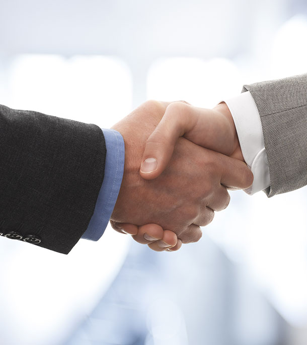 Two suited hands in handshake